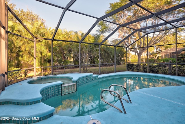 view of swimming pool featuring an in ground hot tub and a lanai