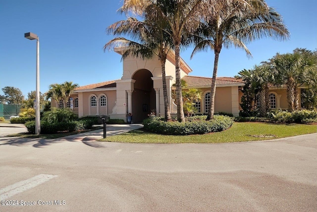 mediterranean / spanish-style home featuring a front lawn