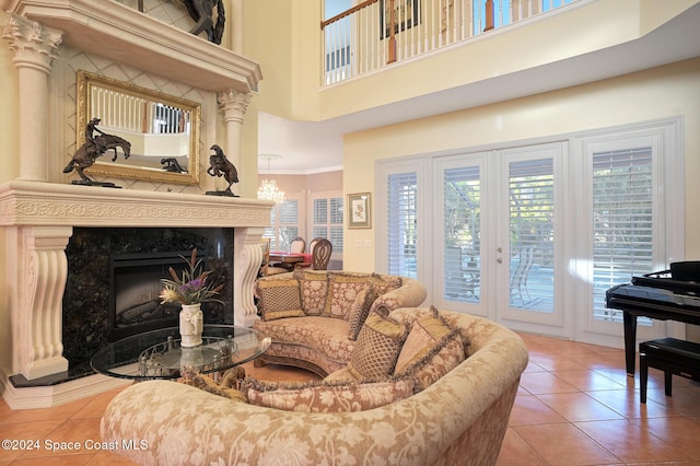 tiled living room with a premium fireplace, crown molding, and a high ceiling