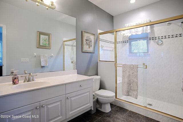 bathroom featuring toilet, vanity, and walk in shower