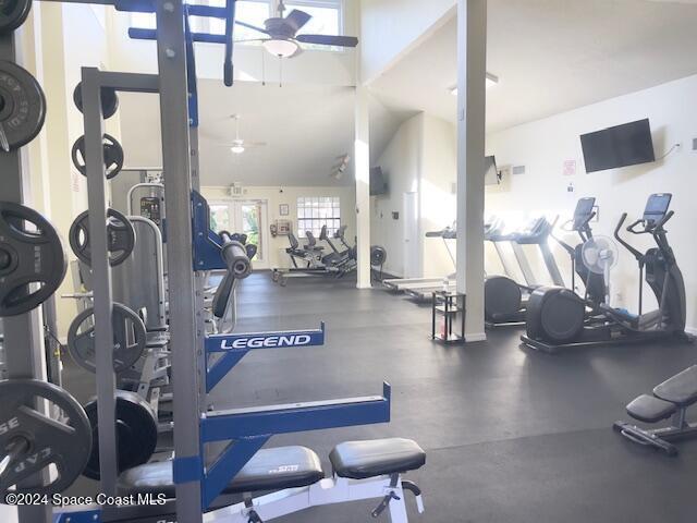 workout area featuring ceiling fan and vaulted ceiling