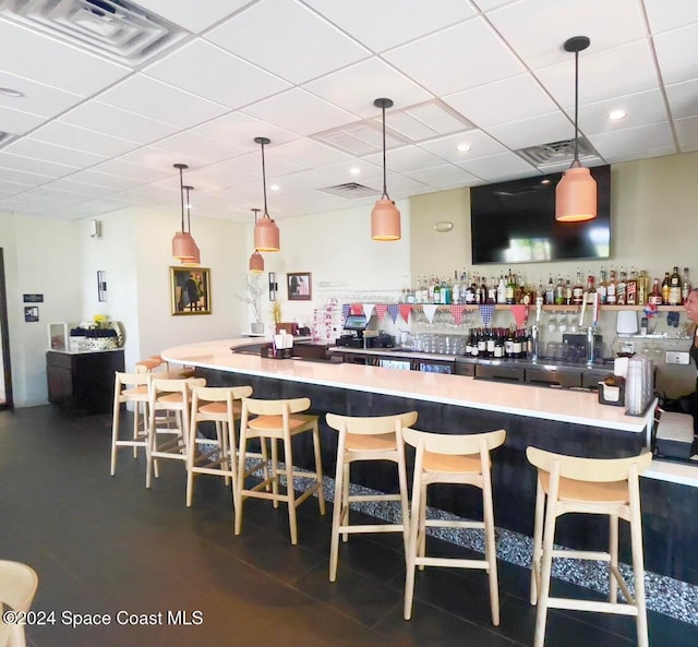 bar featuring a drop ceiling