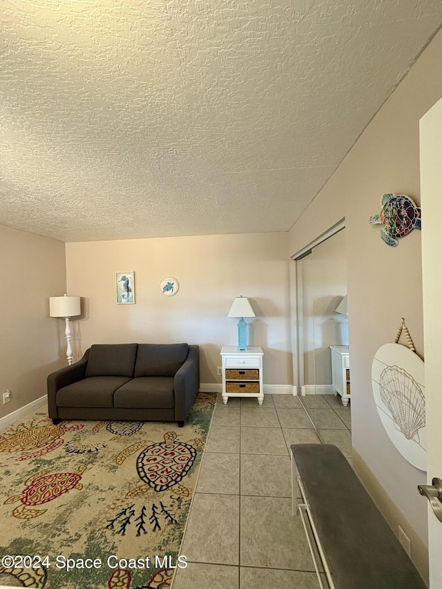 living room with light tile patterned floors and a textured ceiling