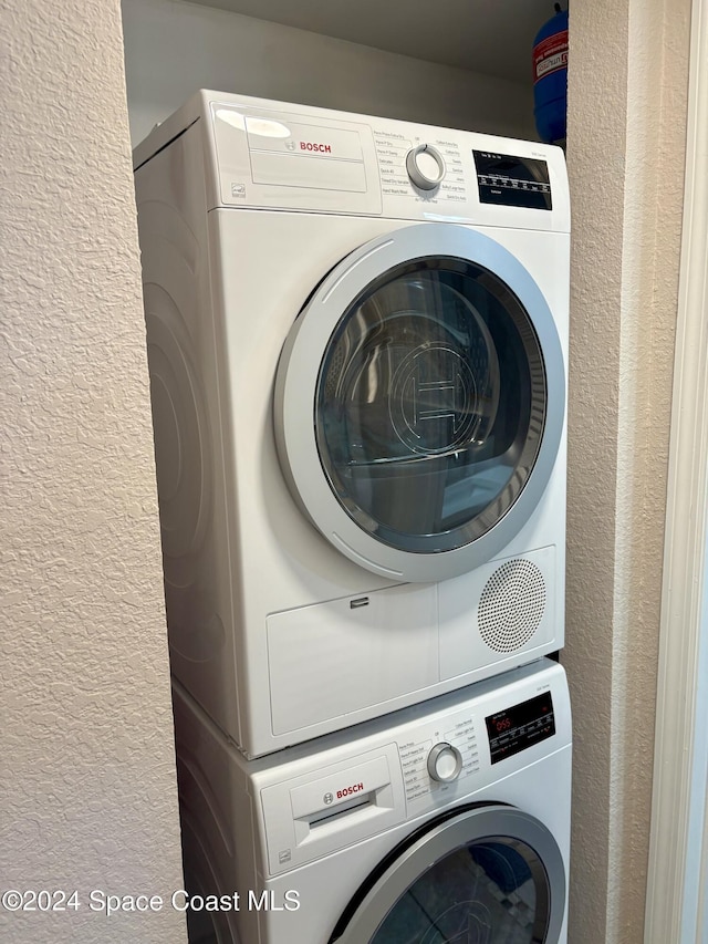 washroom with stacked washer / dryer