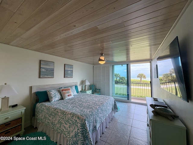 tiled bedroom with access to exterior and wooden ceiling