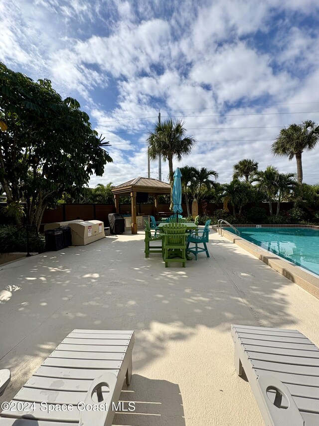 view of swimming pool with a gazebo and a patio