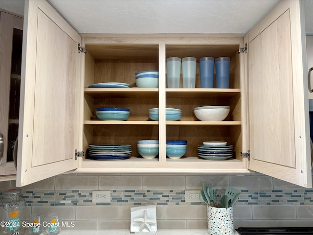 interior details featuring tasteful backsplash and light brown cabinets