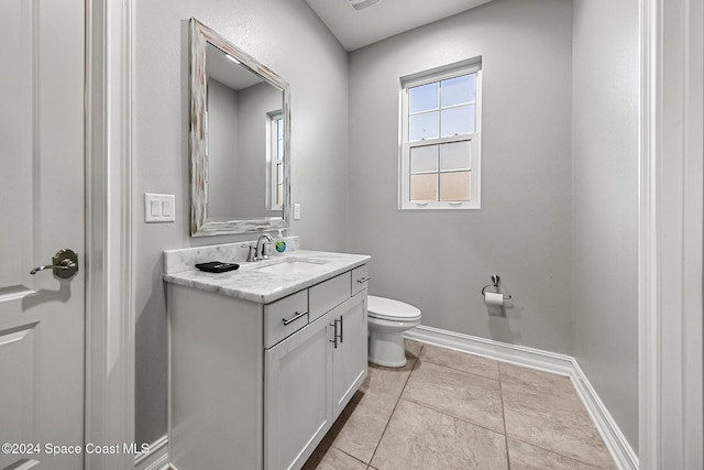 bathroom with tile patterned floors, vanity, and toilet