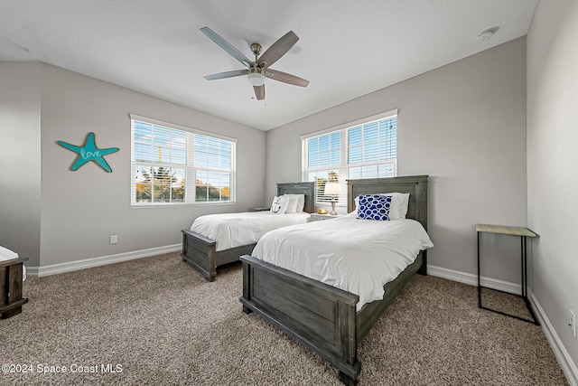 carpeted bedroom featuring ceiling fan and lofted ceiling