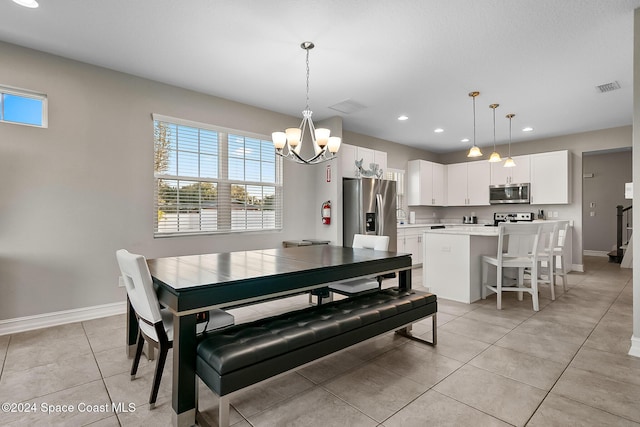 dining area with light tile patterned flooring and an inviting chandelier