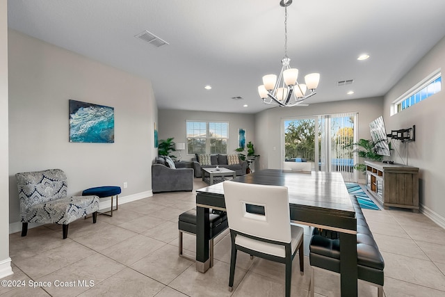 dining room featuring light tile patterned floors and a chandelier