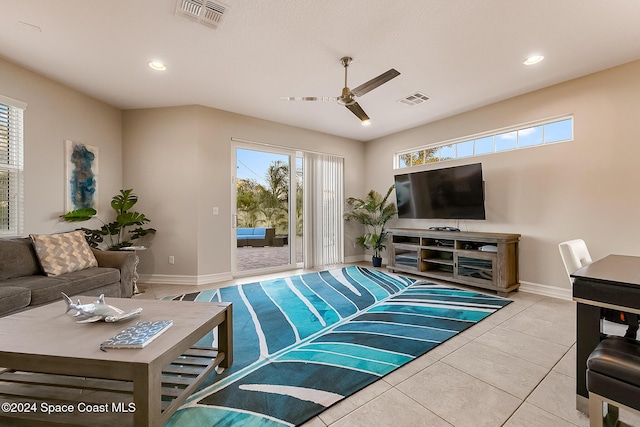 tiled living room with ceiling fan