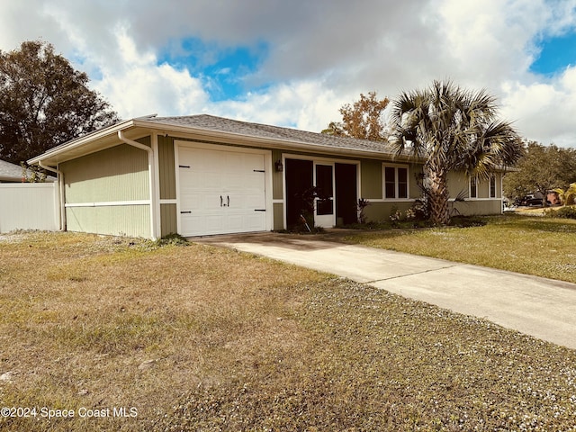 single story home with a garage and a front lawn