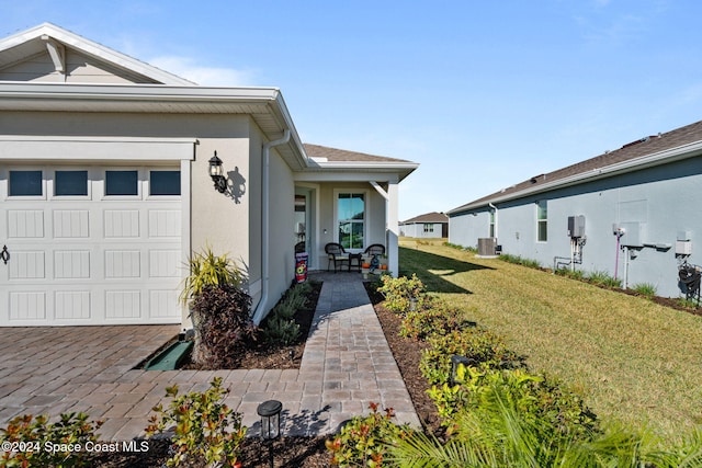 view of side of property with a garage, central AC unit, and a lawn