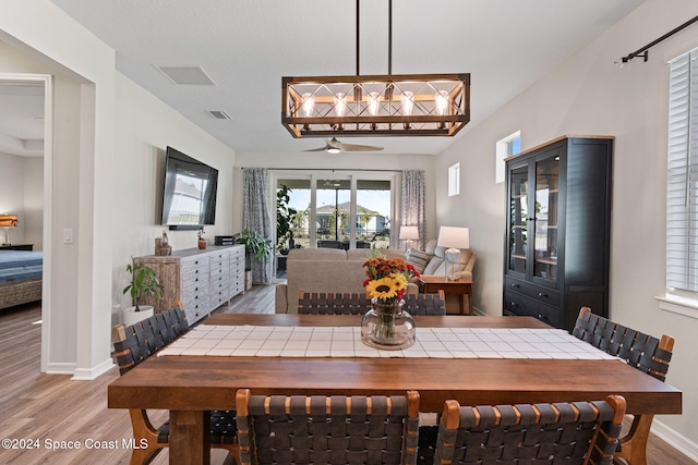 dining area with wood-type flooring and ceiling fan