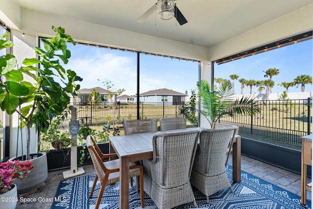 sunroom featuring ceiling fan