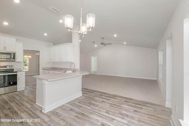 kitchen featuring white cabinets, ceiling fan with notable chandelier, sink, vaulted ceiling, and stainless steel appliances