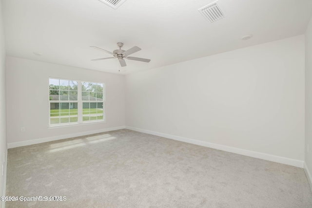 carpeted spare room with ceiling fan