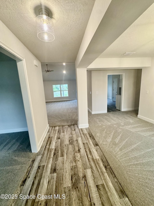 725 De Groodt Rd SW, Palm Bay, FL 32908 - carpeted spare room with a textured ceiling, baseboards, wood finished floors, and ceiling fan