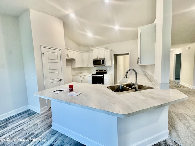 725 De Groodt Rd SW, Palm Bay, FL 32908 - kitchen featuring stainless steel microwave, a sink, range with electric stovetop, a peninsula, and vaulted ceiling