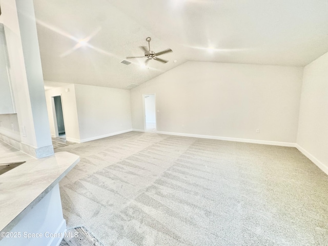 725 De Groodt Rd SW, Palm Bay, FL 32908 - unfurnished living room featuring a ceiling fan, light colored carpet, lofted ceiling, and baseboards