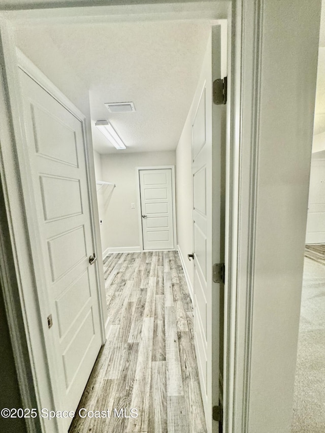 725 De Groodt Rd SW, Palm Bay, FL 32908 - hallway featuring light wood-style flooring and baseboards