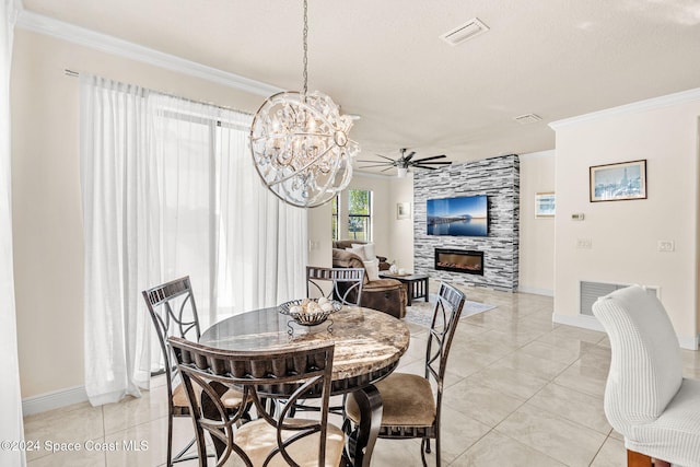 tiled dining room with a fireplace, a textured ceiling, ceiling fan, and ornamental molding