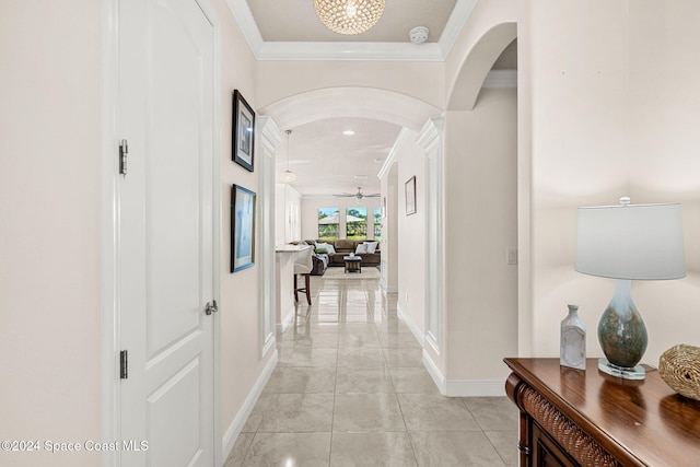 hall featuring crown molding and light tile patterned flooring