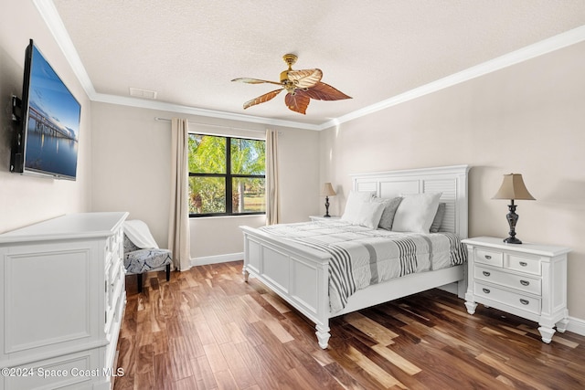 bedroom featuring a textured ceiling, dark hardwood / wood-style flooring, ceiling fan, and ornamental molding