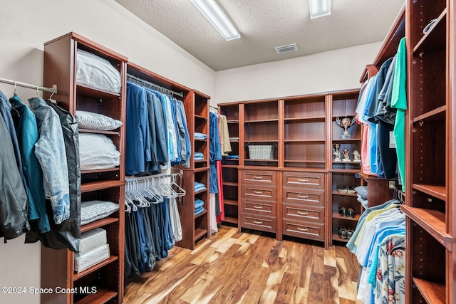 walk in closet featuring light hardwood / wood-style flooring