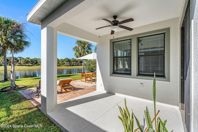 view of patio / terrace with a water view and ceiling fan