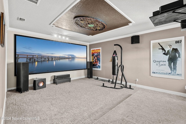 carpeted home theater with a textured ceiling and ornamental molding