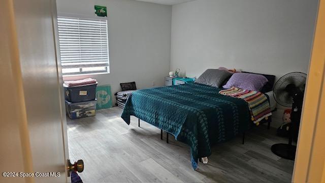 bedroom with hardwood / wood-style floors