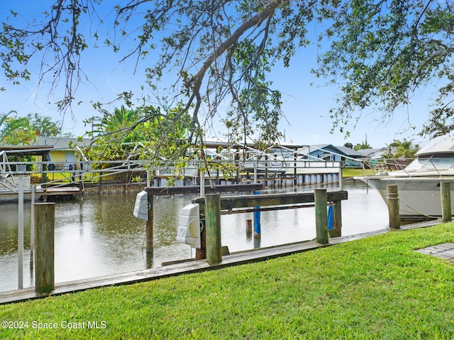 dock area featuring a water view and a yard