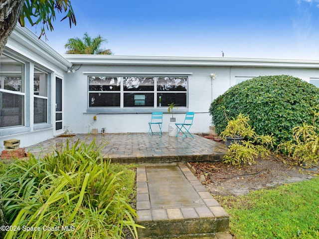 property entrance featuring a patio area