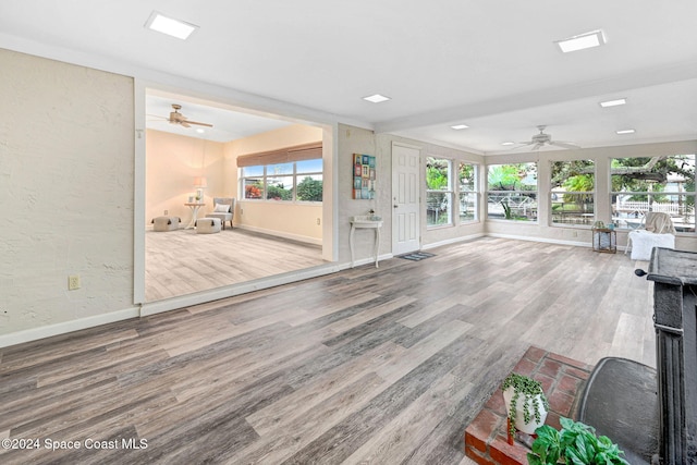 unfurnished living room with ceiling fan and hardwood / wood-style flooring