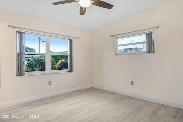 spare room featuring light hardwood / wood-style flooring, plenty of natural light, lofted ceiling, and ceiling fan