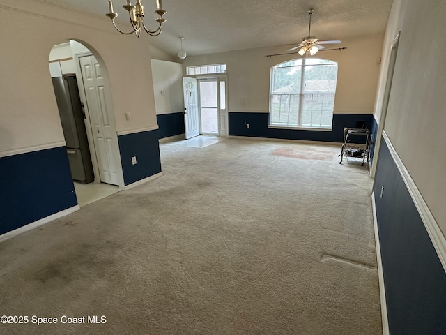 7444 Glenwood Rd, Cocoa, FL 32927 - carpeted spare room with a ceiling fan, a chandelier, arched walkways, and a textured ceiling