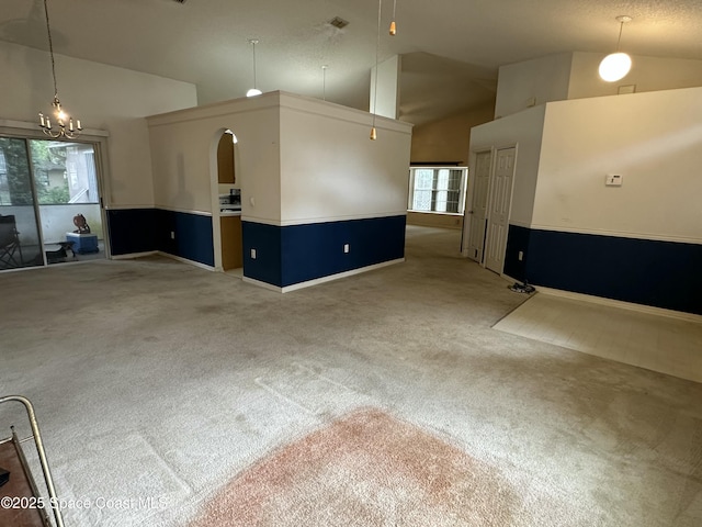 7444 Glenwood Rd, Cocoa, FL 32927 - empty room with light carpet, a chandelier, and high vaulted ceiling