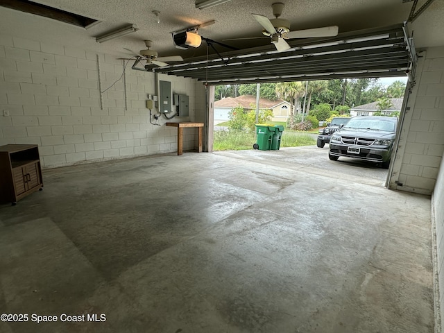 7444 Glenwood Rd, Cocoa, FL 32927 - garage with a garage door opener, ceiling fan, concrete block wall, and electric panel