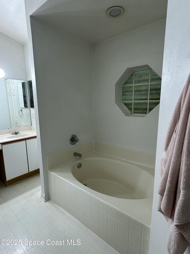 7444 Glenwood Rd, Cocoa, FL 32927 - full bathroom with vanity, a garden tub, and tile patterned floors