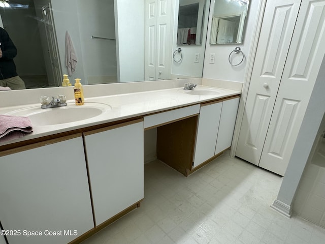 7444 Glenwood Rd, Cocoa, FL 32927 - bathroom featuring a closet, double vanity, and tile patterned floors