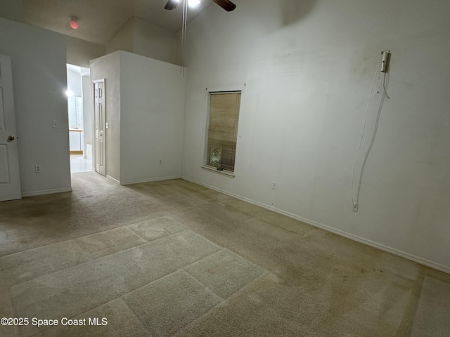 7444 Glenwood Rd, Cocoa, FL 32927 - spare room with light colored carpet, a ceiling fan, and a towering ceiling