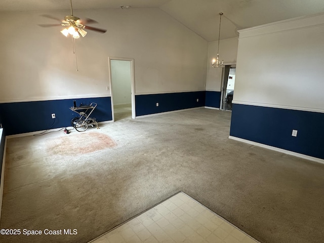7444 Glenwood Rd, Cocoa, FL 32927 - unfurnished living room featuring vaulted ceiling, a ceiling fan, a chandelier, and carpet