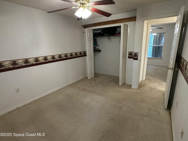 7444 Glenwood Rd, Cocoa, FL 32927 - unfurnished bedroom featuring light colored carpet, a textured ceiling, a closet, and ceiling fan