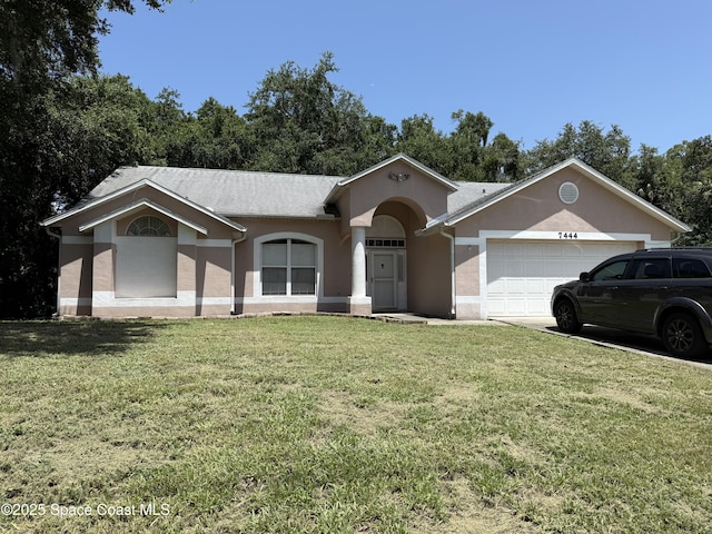 7444 Glenwood Rd, Cocoa, FL 32927 - single story home with an attached garage, a front yard, stucco siding, and concrete driveway