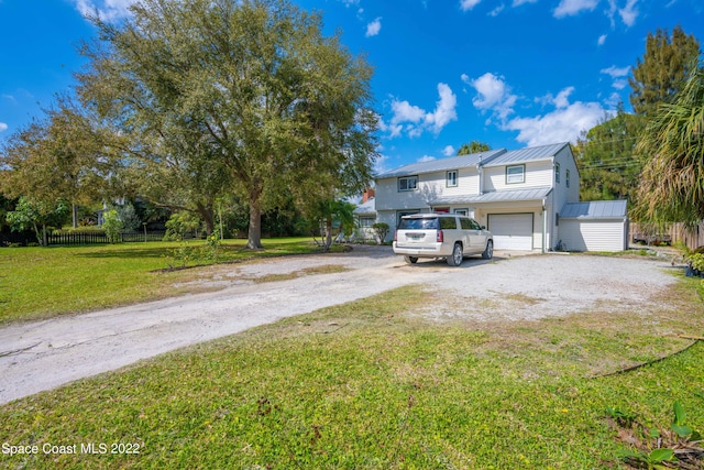 view of front of home with a front yard and a garage