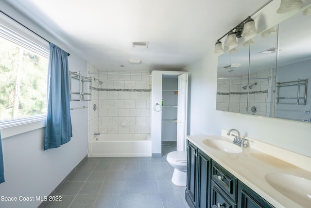 full bathroom featuring vanity, toilet, and tiled shower / bath