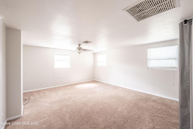 carpeted empty room featuring ceiling fan