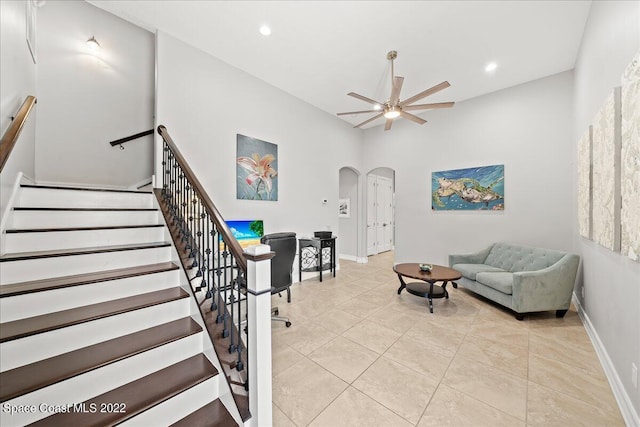 living room featuring ceiling fan and light tile patterned flooring